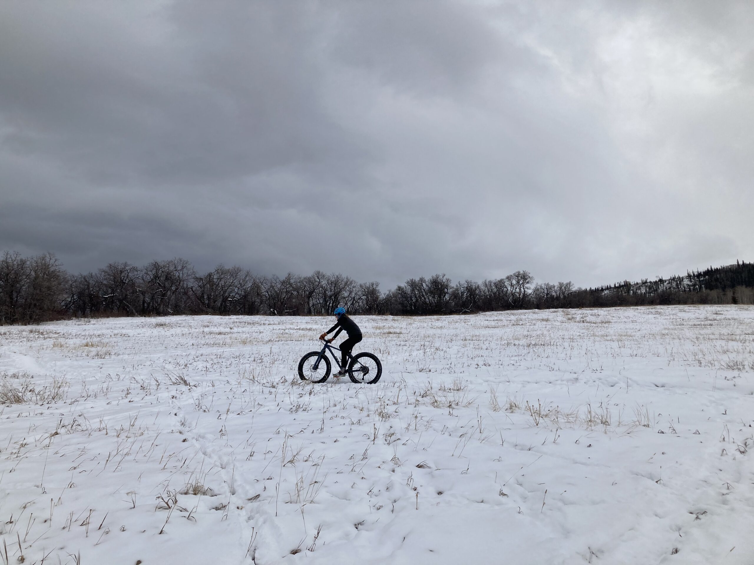 A person riding a bike in the snow.
