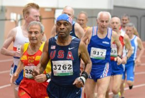 Senior athletes competing in an indoor race.
