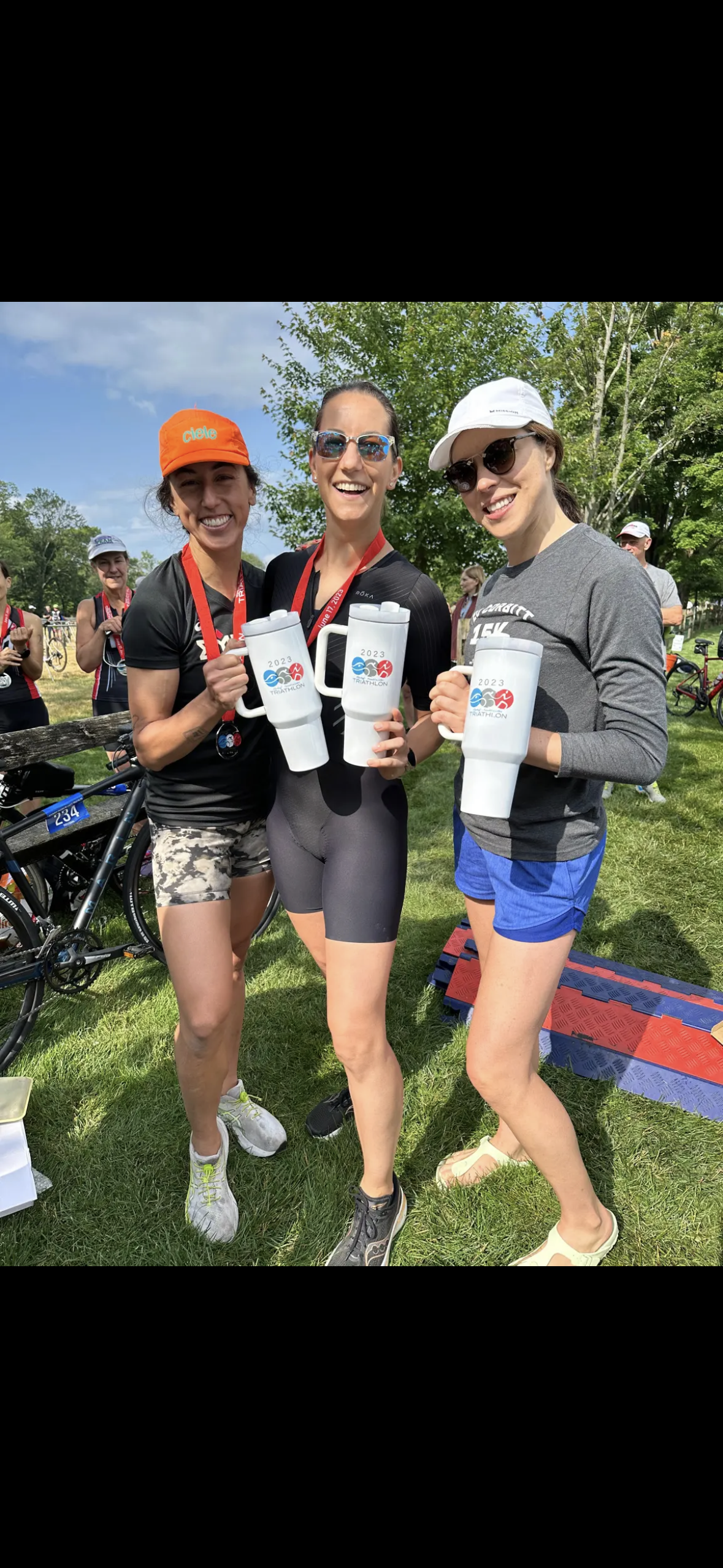 Three women holding cups in their hands.